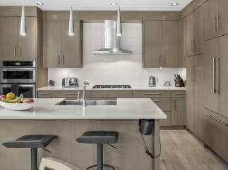 Experience modern luxury in this stunning kitchen, featuring sleek, custom cabinetry and high-end stainless steel appliances.