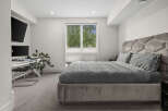 Experience modern comfort in this stylish bedroom, featuring a plush velvet headboard with integrated lighting and a luxurious grey duvet set.