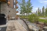 Enjoy outdoor living with this charming patio featuring a gas grill and a cozy fire pit area, perfect for entertaining.