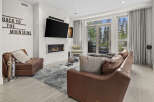 Experience modern mountain living in this stunning living room, featuring a sleek gas fireplace and a large flat-screen TV mounted above.