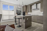 Experience modern luxury in this stunning kitchen featuring sleek, grey cabinetry and a spacious island perfect for entertaining.