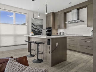 Experience modern luxury in this stunning kitchen featuring sleek, grey cabinetry and a spacious island perfect for entertaining.