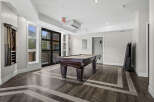 Enjoy endless entertainment in this stylish game room, featuring a classic billiard table perfect for friendly competitions.