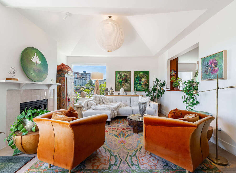 Experience sophisticated living in this stunning living room, featuring plush orange velvet armchairs and a sleek white sectional sofa perfect for relaxation.