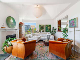 Experience sophisticated living in this stunning living room, featuring plush orange velvet armchairs and a sleek white sectional sofa perfect for relaxation.