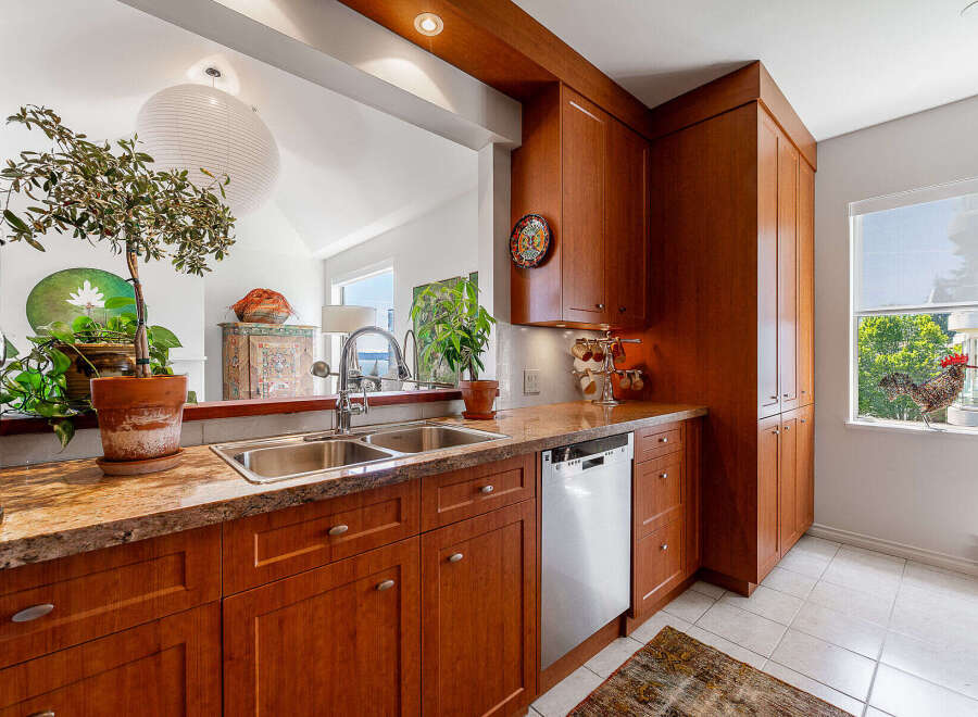 Discover this charming kitchen featuring warm cherry wood cabinetry and elegant granite countertops.