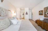 Experience comfort and style in this beautifully appointed bedroom, featuring a plush bed adorned with decorative pillows and a textured quilt.