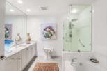 Indulge in luxury in this stunning master bathroom, featuring a spacious walk-in shower with a rainfall showerhead and a deep soaking tub perfect for relaxation.