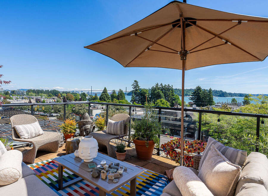 Enjoy breathtaking panoramic views from this stunning rooftop patio, perfect for entertaining or relaxing.