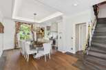 Experience elegant dining in this luxurious home, featuring a spacious dining room with a grand chandelier and seating for ten.