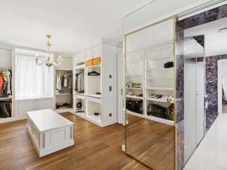 Step into this luxurious walk-in closet, featuring custom built-in shelving and ample hanging space for your extensive wardrobe.