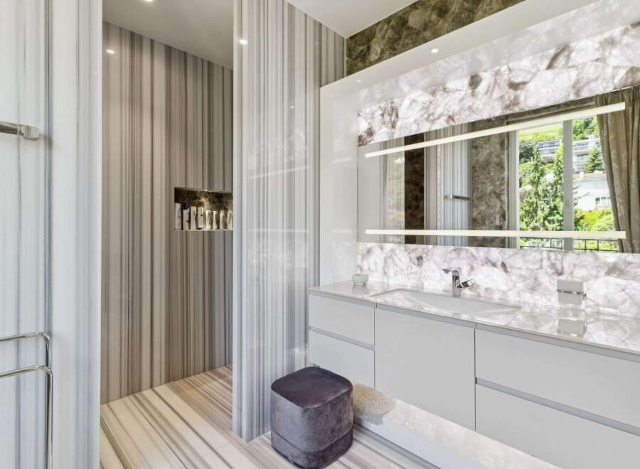 Experience luxury in this modern bathroom featuring exquisite marble finishes throughout.