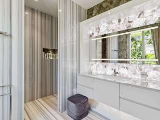 Experience luxury in this modern bathroom featuring exquisite marble finishes throughout.