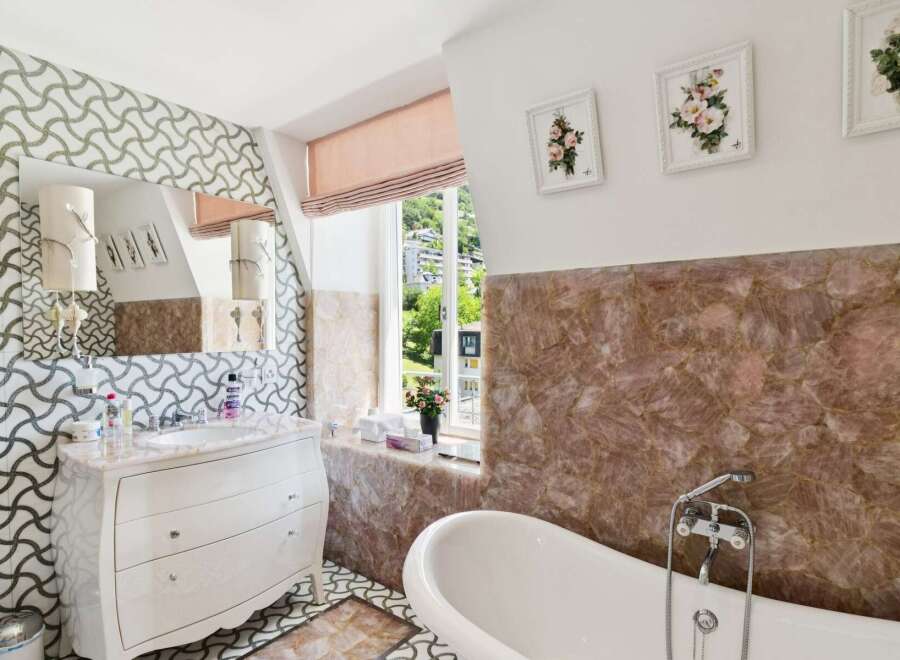 Indulge in luxury with this stunning bathroom featuring a freestanding bathtub and a sophisticated vanity.