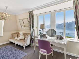 Experience breathtaking lake and mountain views from this elegant room, perfect for relaxation and rejuvenation.