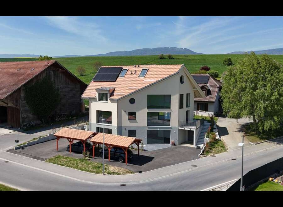 Discover this modern architectural gem featuring a striking facade with expansive windows and a unique circular accent.