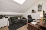 Discover this inviting attic space, perfect for a home office or cozy living area.