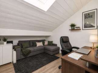Discover this inviting attic space, perfect for a home office or cozy living area.