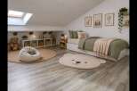 Discover this charming attic bedroom, perfect for a child's sanctuary.