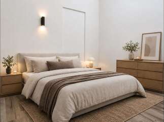 Experience serene comfort in this beautifully appointed bedroom, featuring a plush king-size bed with luxurious linen bedding and a cozy throw.