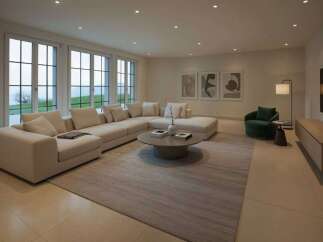 Experience luxurious living in this spacious living room, featuring a large sectional sofa perfect for gatherings and a modern coffee table.