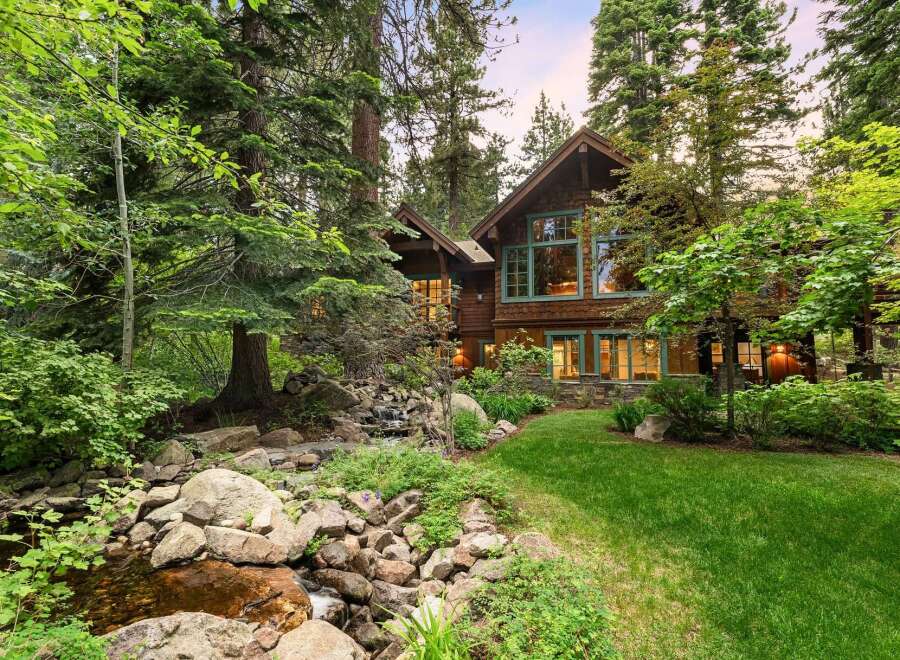 Nestled amidst lush greenery and mature trees, this stunning mountain home offers a serene retreat.