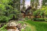 Nestled amidst lush greenery and mature trees, this stunning mountain home offers a serene retreat.