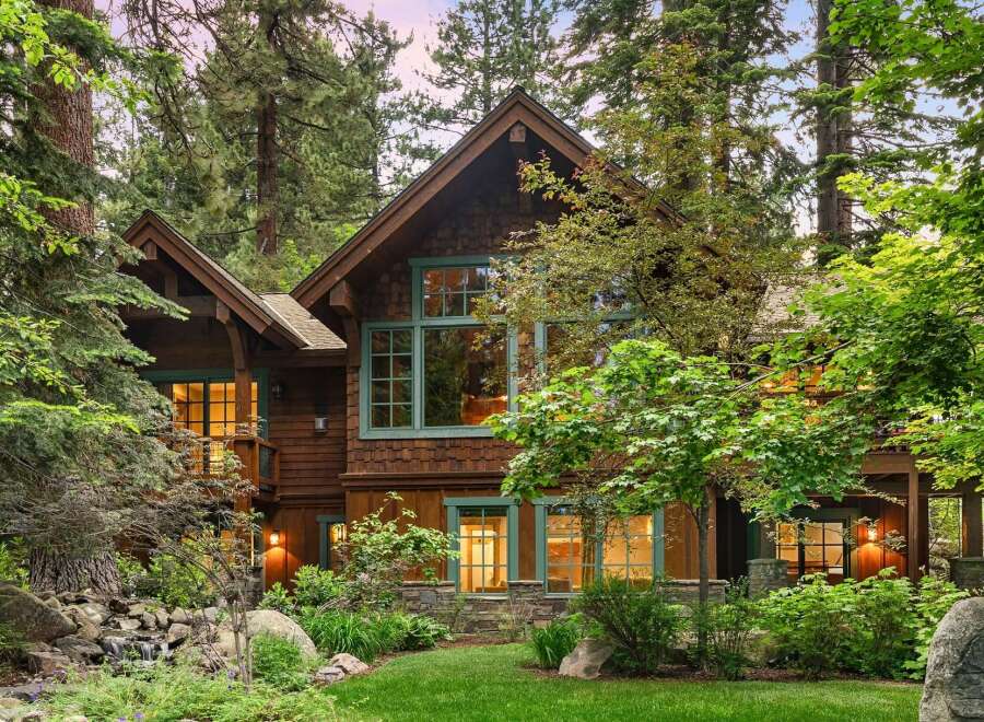 Nestled amidst towering trees, this stunning mountain home offers a serene retreat with its rustic charm and natural beauty.