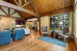 Experience rustic elegance in this spacious living area, featuring a stunning vaulted ceiling with exposed wooden beams and a warm, inviting atmosphere.