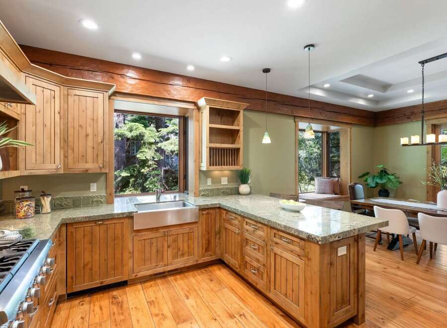 Experience rustic charm in this spacious kitchen featuring custom wood cabinetry and granite countertops.