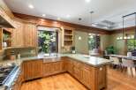Experience rustic charm in this spacious kitchen featuring custom wood cabinetry and granite countertops.