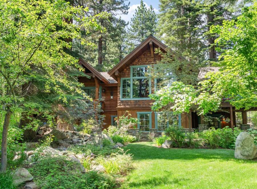 Nestled amidst lush greenery and mature trees, this stunning mountain home offers a serene retreat.
