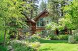 Nestled amidst lush greenery and mature trees, this stunning mountain home offers a serene retreat.