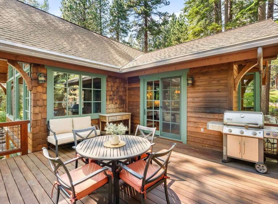 Enjoy outdoor living on this spacious wooden deck, perfect for entertaining or relaxing amidst nature.
