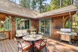 Enjoy outdoor living on this spacious wooden deck, perfect for entertaining or relaxing amidst nature.