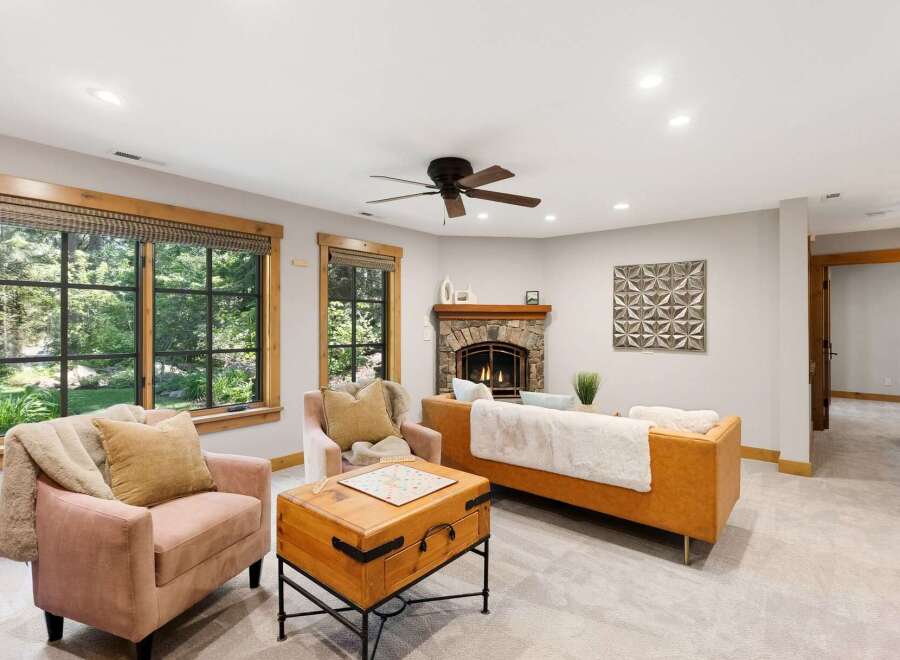 Step into this inviting living room featuring a cozy stone fireplace and comfortable seating.