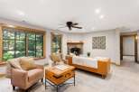 Step into this inviting living room featuring a cozy stone fireplace and comfortable seating.
