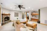 Cozy up by the stone fireplace in this inviting living space, perfect for family gatherings.
