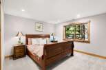 Experience serene living in this charming bedroom, featuring a beautiful wooden sleigh bed and coordinating nightstands.