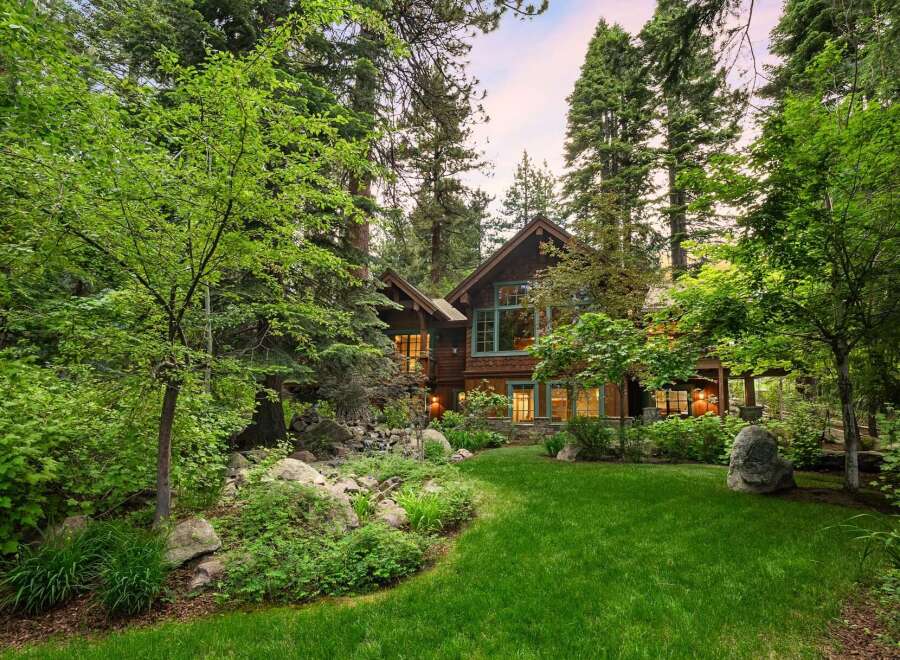 Nestled amidst towering trees and lush greenery, this stunning mountain home offers a serene retreat.