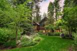 Nestled amidst towering trees and lush greenery, this stunning mountain home offers a serene retreat.