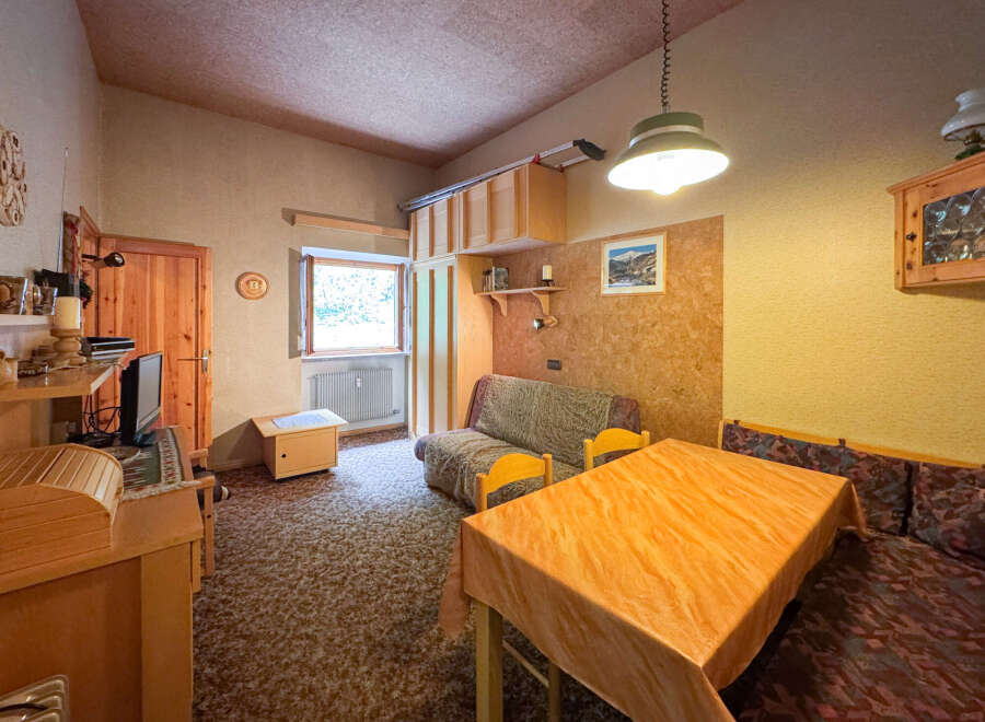 Cozy living space featuring a comfortable sofa and a dining area with a table and chairs.