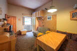 Cozy living space featuring a comfortable sofa and a dining area with a table and chairs.