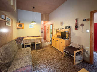 Cozy living room featuring a comfortable sofa and a dining area with a table and chairs.