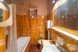 This vintage bathroom features a classic clawfoot bathtub with a shower curtain, perfect for a relaxing soak.