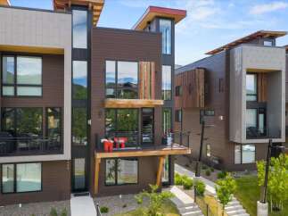 Experience modern luxury in this stunning multi-story residence featuring a striking architectural design with warm wood accents and sleek metal detailing.