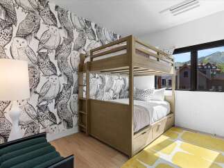 This charming bedroom features a playful owl-themed wallpaper that adds a whimsical touch.