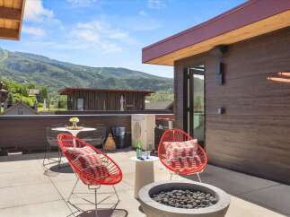Enjoy breathtaking mountain views from this stunning rooftop patio, perfect for entertaining or relaxing.