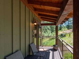 Enjoy the serene mountain views from this charming covered porch, perfect for morning coffee or evening relaxation.
