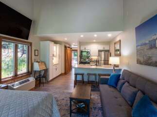 Discover this charming studio apartment featuring a well-equipped kitchenette with stainless steel appliances and a breakfast bar, perfect for casual dining.